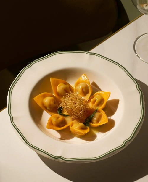 Handmade tortelli pasta in a bowl at Osteria Da Su